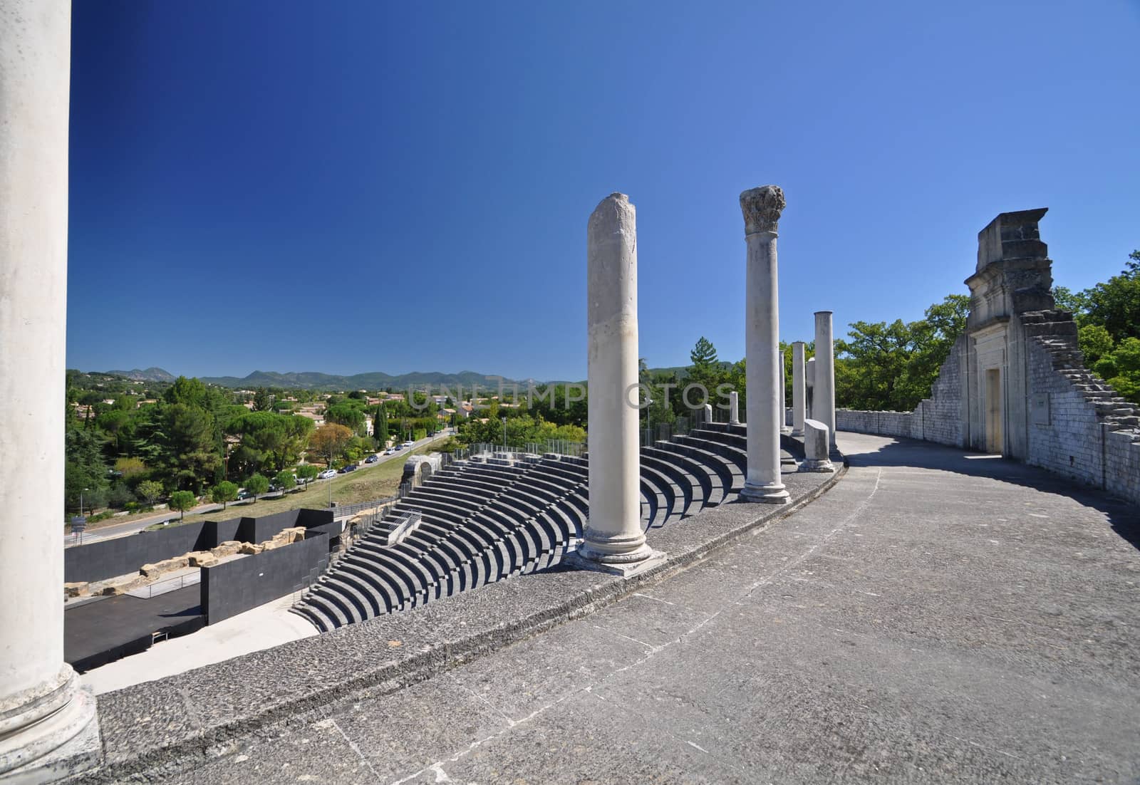 The extensive Roman ruins at Vaison-La-Romaine, Provence, France. These Gallo-Roman remains are situated in the very centre of the fascinating ancient town of Vaison-La-Romaine. The ruins shown are within the Quartier De Puymin ( Puymin Hill ). The Roman Theatre shown seated 6000 people and was built in the 1st Century. Part of the top gallery Portico remains and is shown.