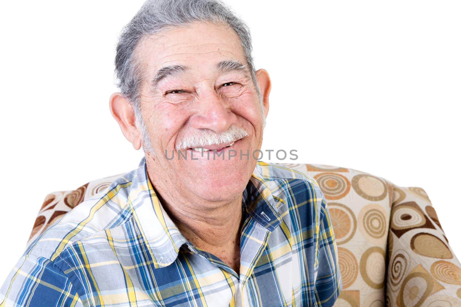Handsome single Mexican man sitting on chair with big smile and mustache in flannel shirt