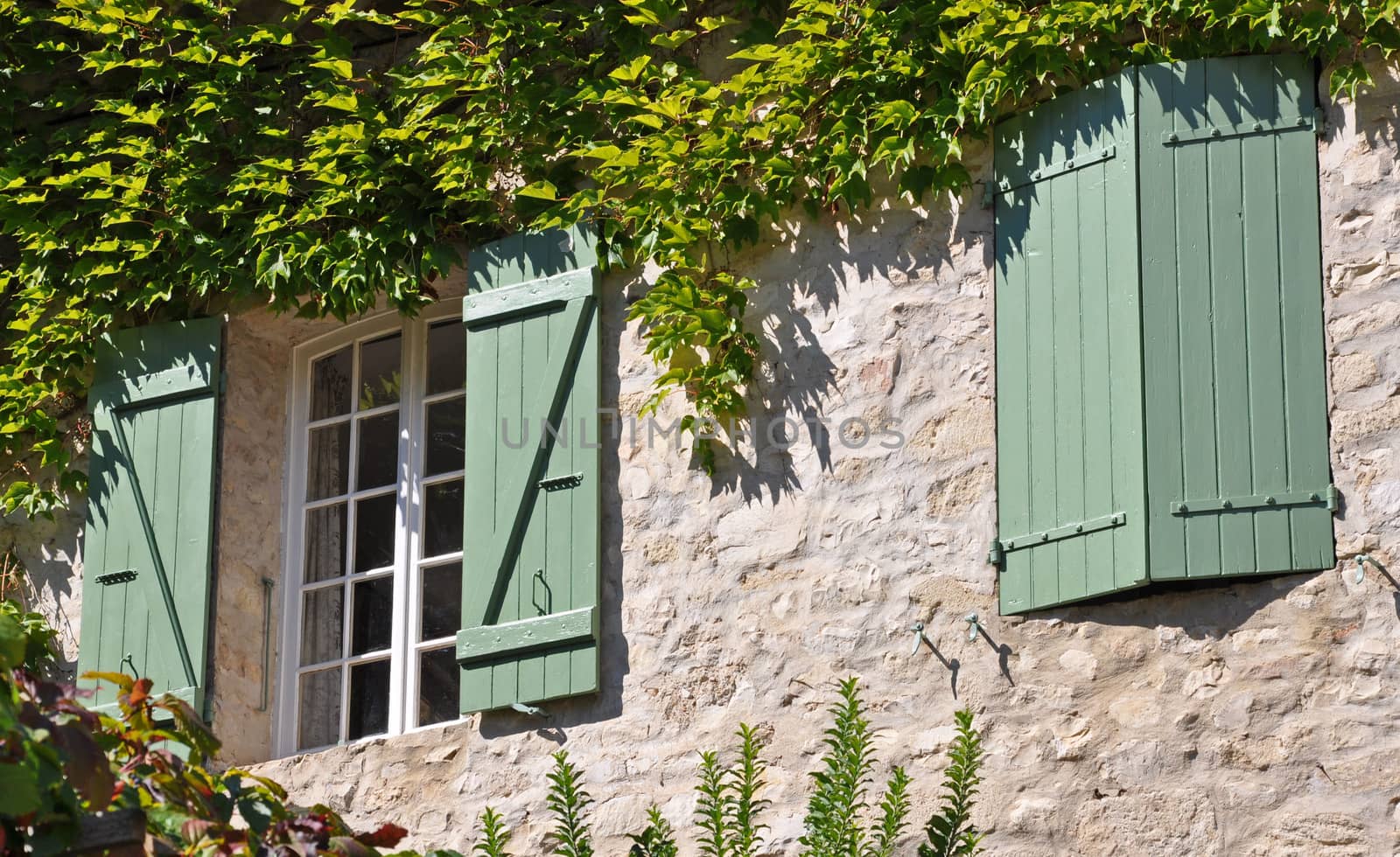 A cottage with green shutters in a Vaison-la-Romaine, in Provence, France.