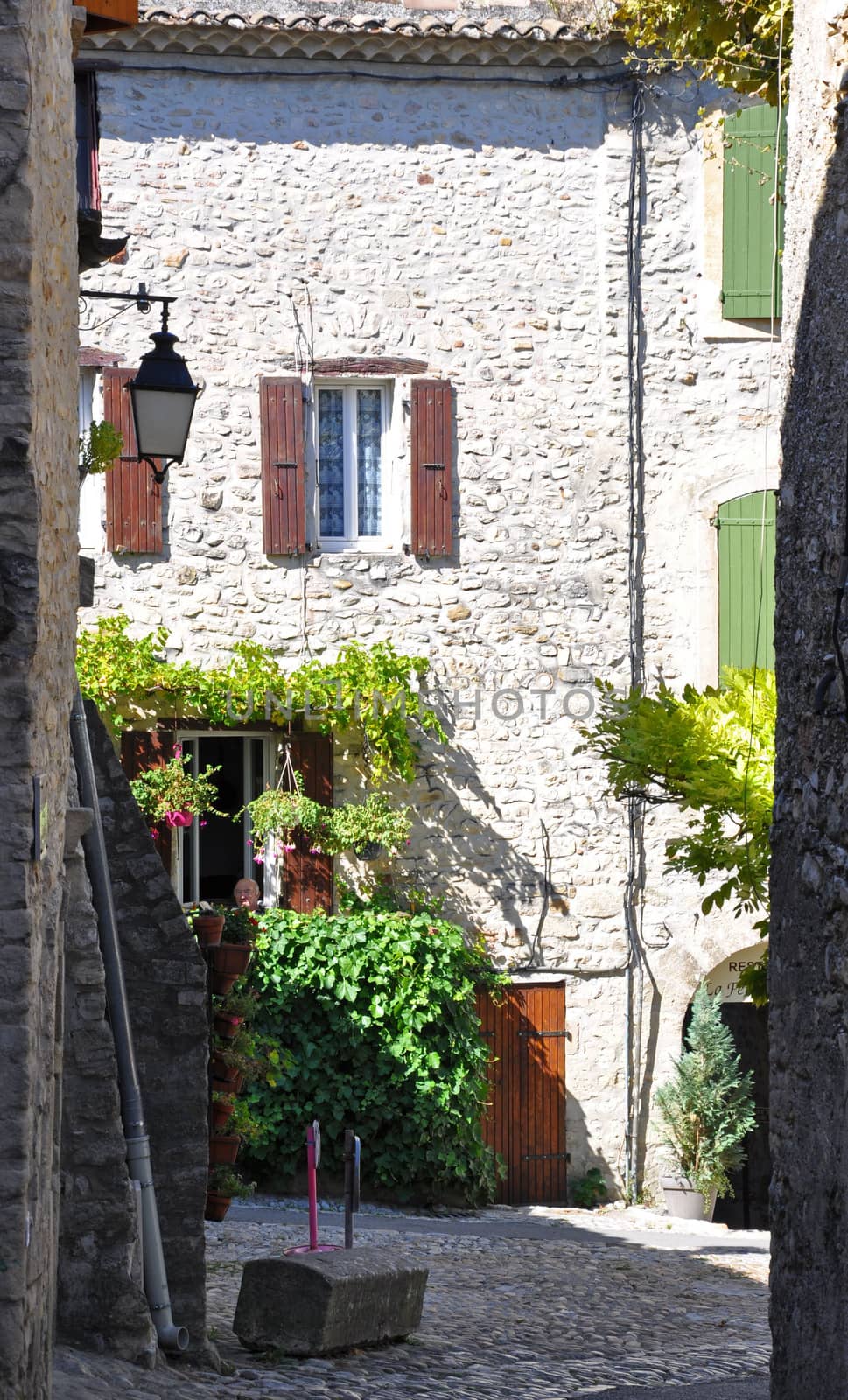 Rue des Fours, as it opens into Place de Vieux-Marche in the old medieval village of Vaison-la-Romaine, in Provence, France. (taken in the Haute Ville)