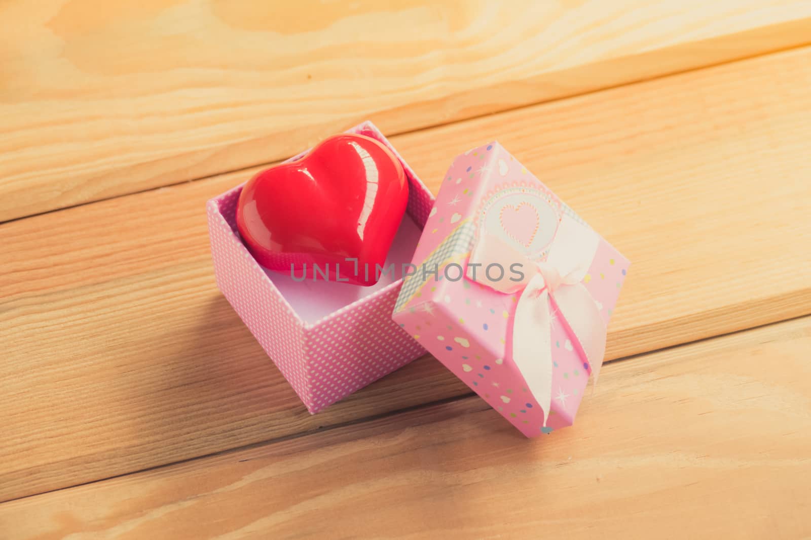 Gift of love. hearty gift. A gift box with a red heart inside. by teerawit