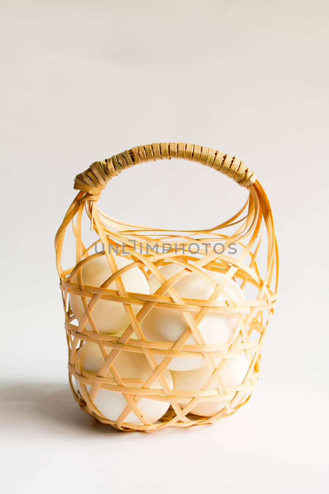 egg in basket wicker on white background,Duck eggs in baskets .