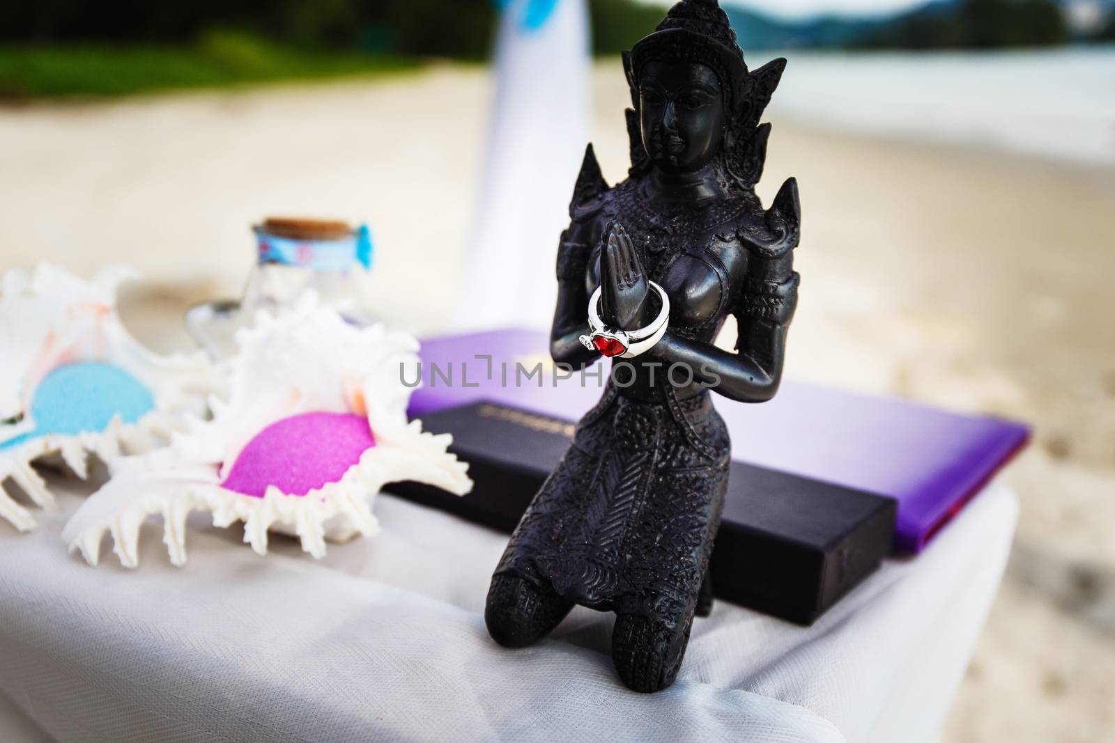 Statue with wedding rings on the beach of Thailand