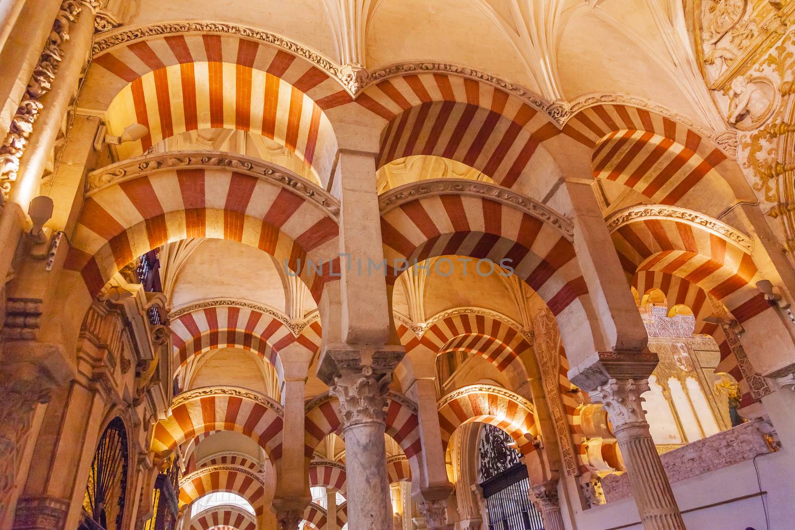 Arches Pillars Mezquita Cordoba Spain.  Created in 785 as a Mosque, was converted to a Cathedral in the 1500.  850 Columns and Arches  