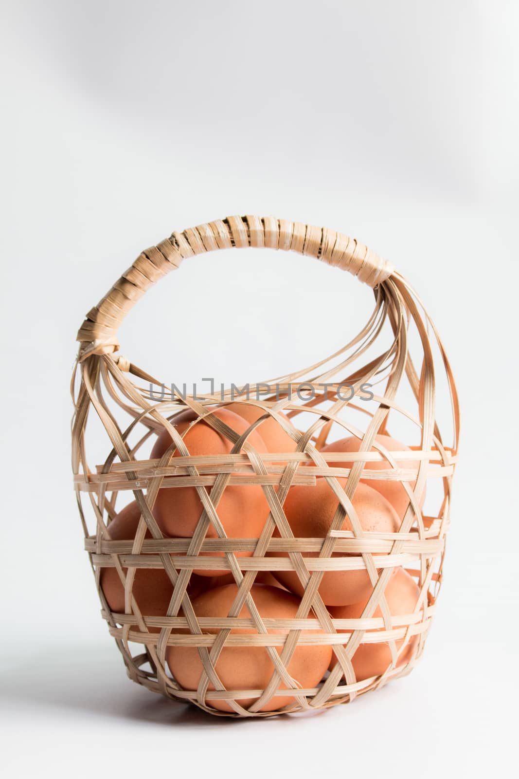 egg in basket wicker on white background,Duck eggs in baskets .