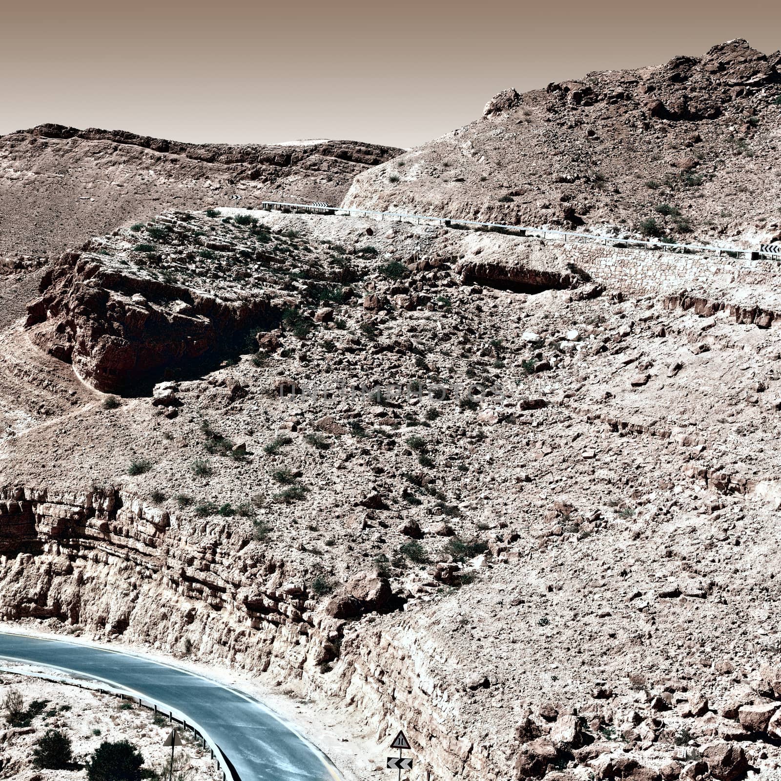 Winding Asphalt Road in the Negev Desert in Israel, Vintage Style Toned Picture