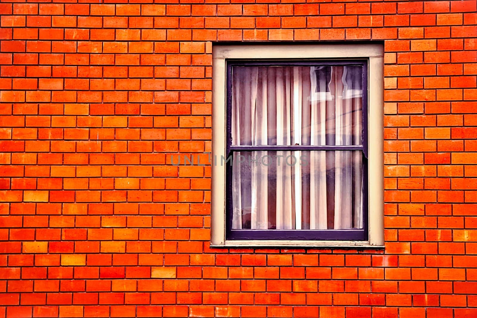 window with old orange brick wall building by Timmi