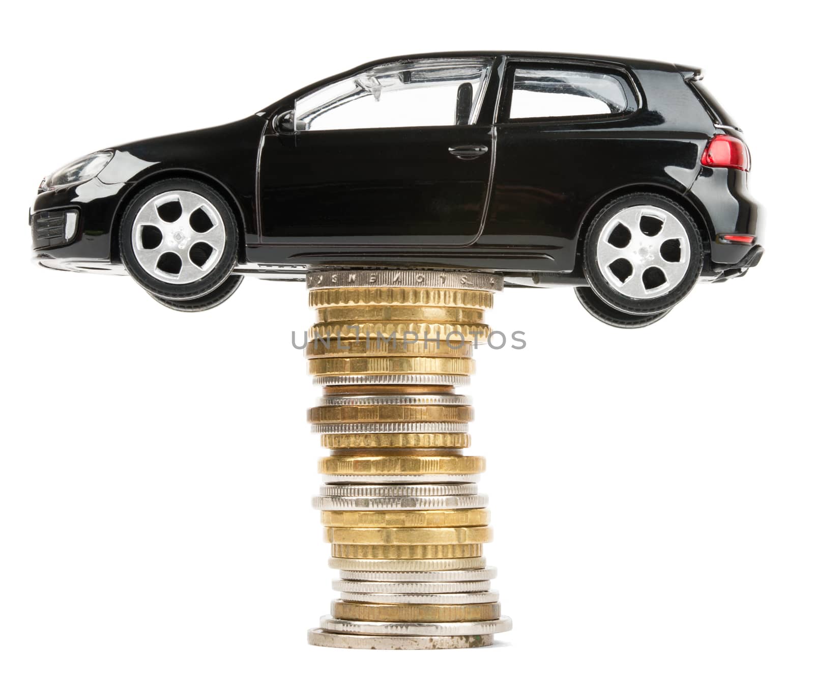 Car on stack of coins isolated on white background