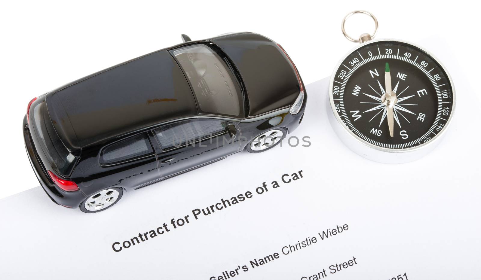 Black car with compass and contract isolated on white background