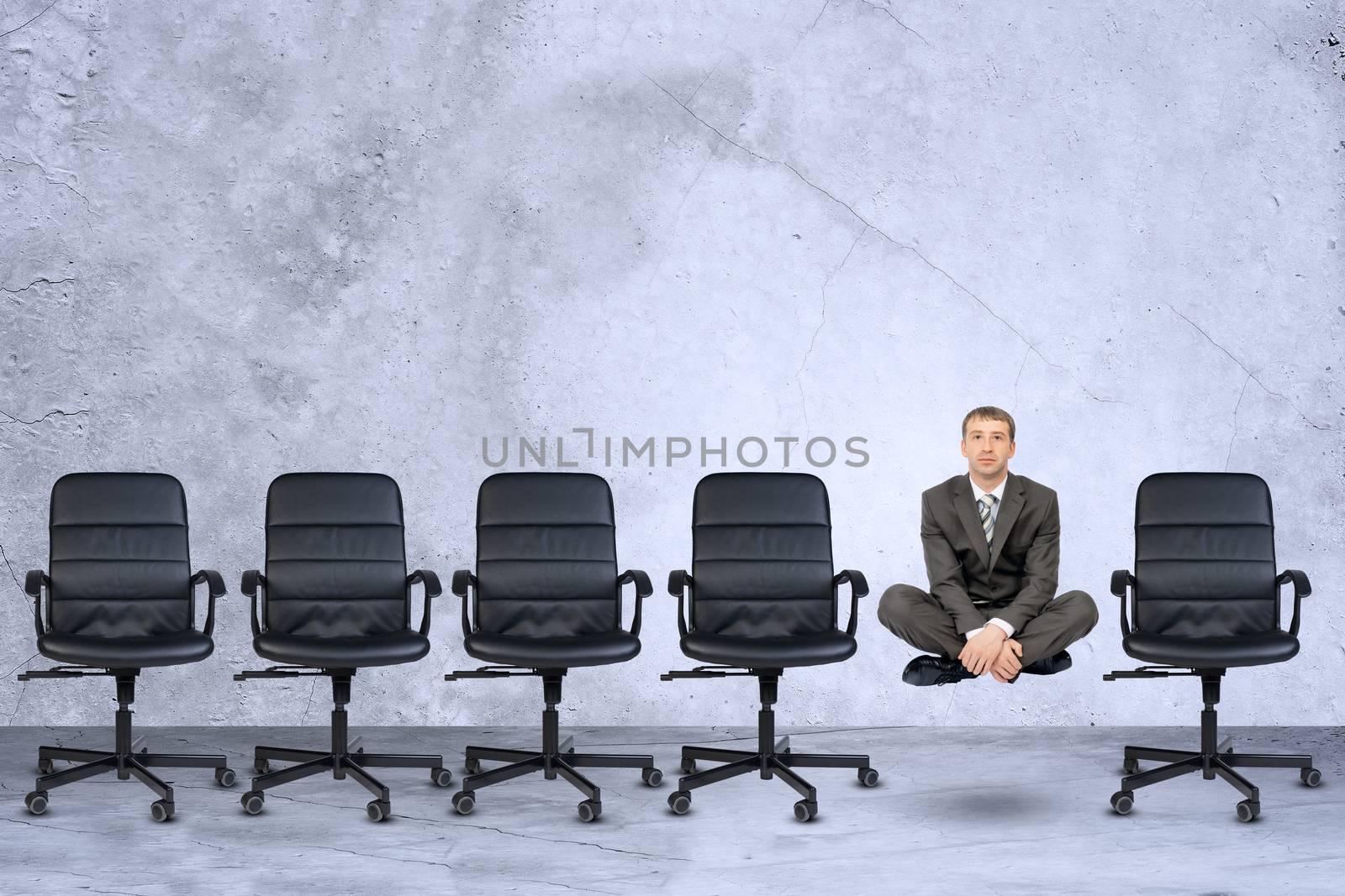 Businessman in lotus posture flying in air on grey background