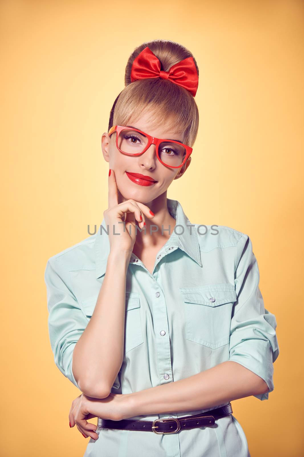 Beauty fashion portrait business woman in stylish red glasses thinking, idea. Attractive pretty blonde girl smiling. Confidence, Pinup hairstyle bow makeup.Unusual playful, emotions.Vintage, on yellow