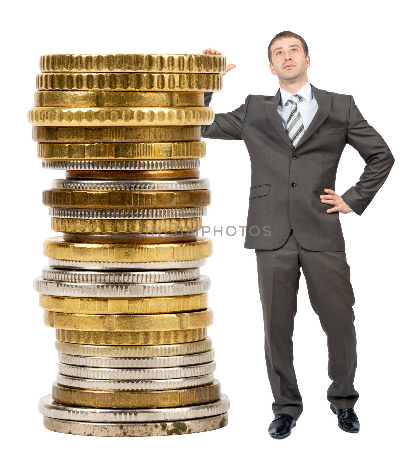 Businessman with big stack of coins isolated on white background