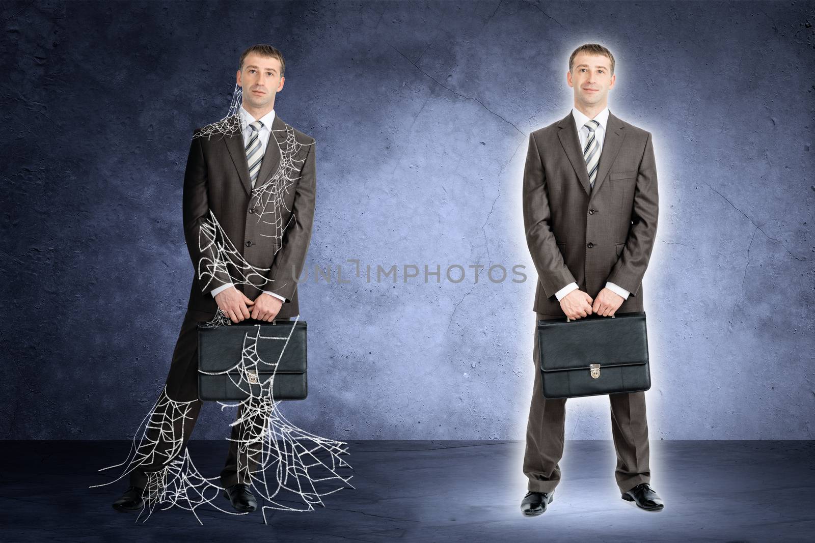 Two businessman in spider web looking at camera on grey background 