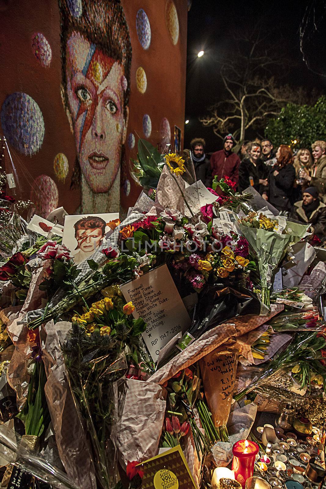UNITED KINGDOM, London: Fans gather during a tribute party to British singer David Bowie on January 11, 2015 in Brixton, South London. British music icon David Bowie died of cancer at the age of 69, drawing an outpouring of tributes for the innovative star famed for groundbreaking hits like Ziggy Stardust and his theatrical shape-shifting style. 