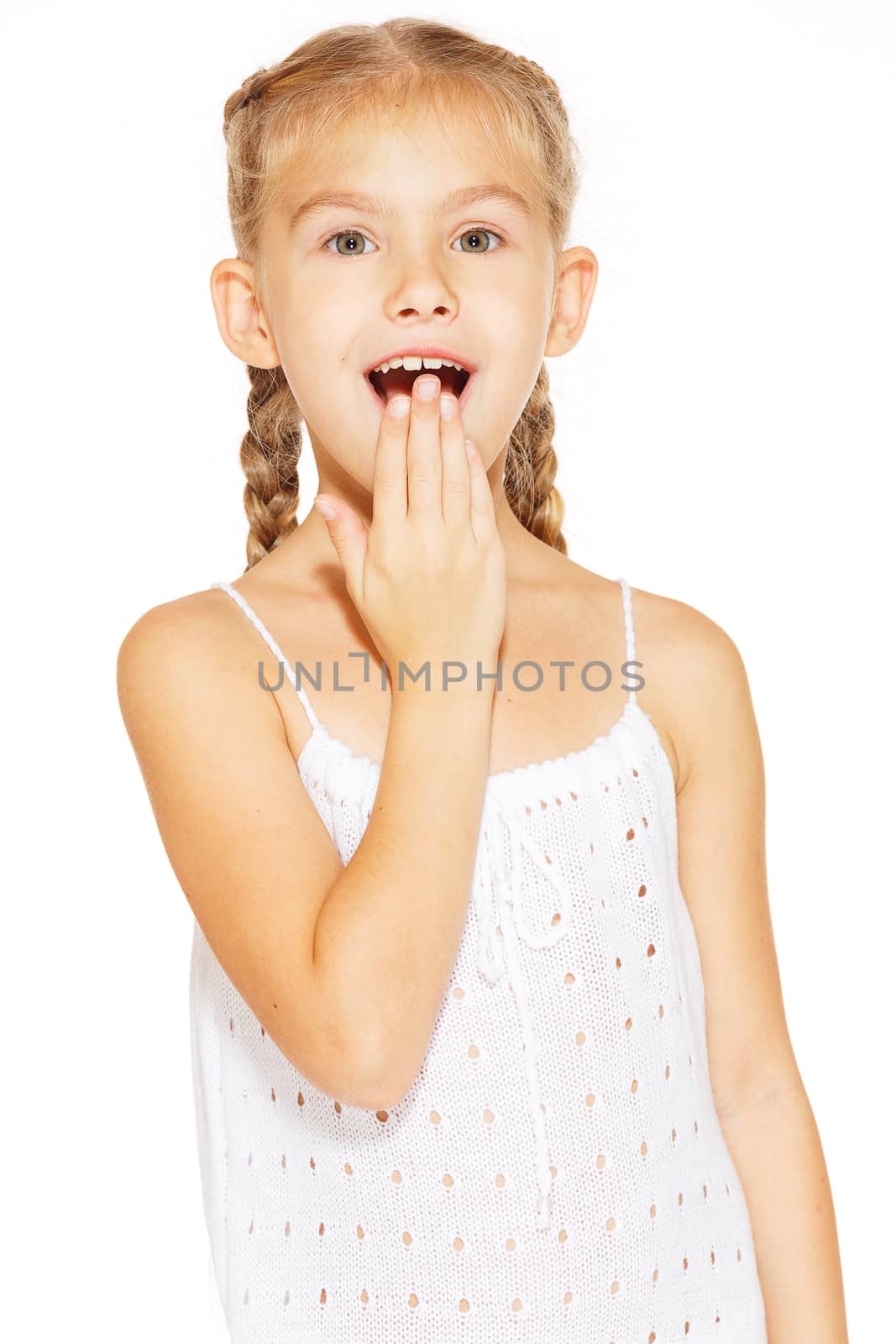 Funny little girl with a charming smile in a white dress 