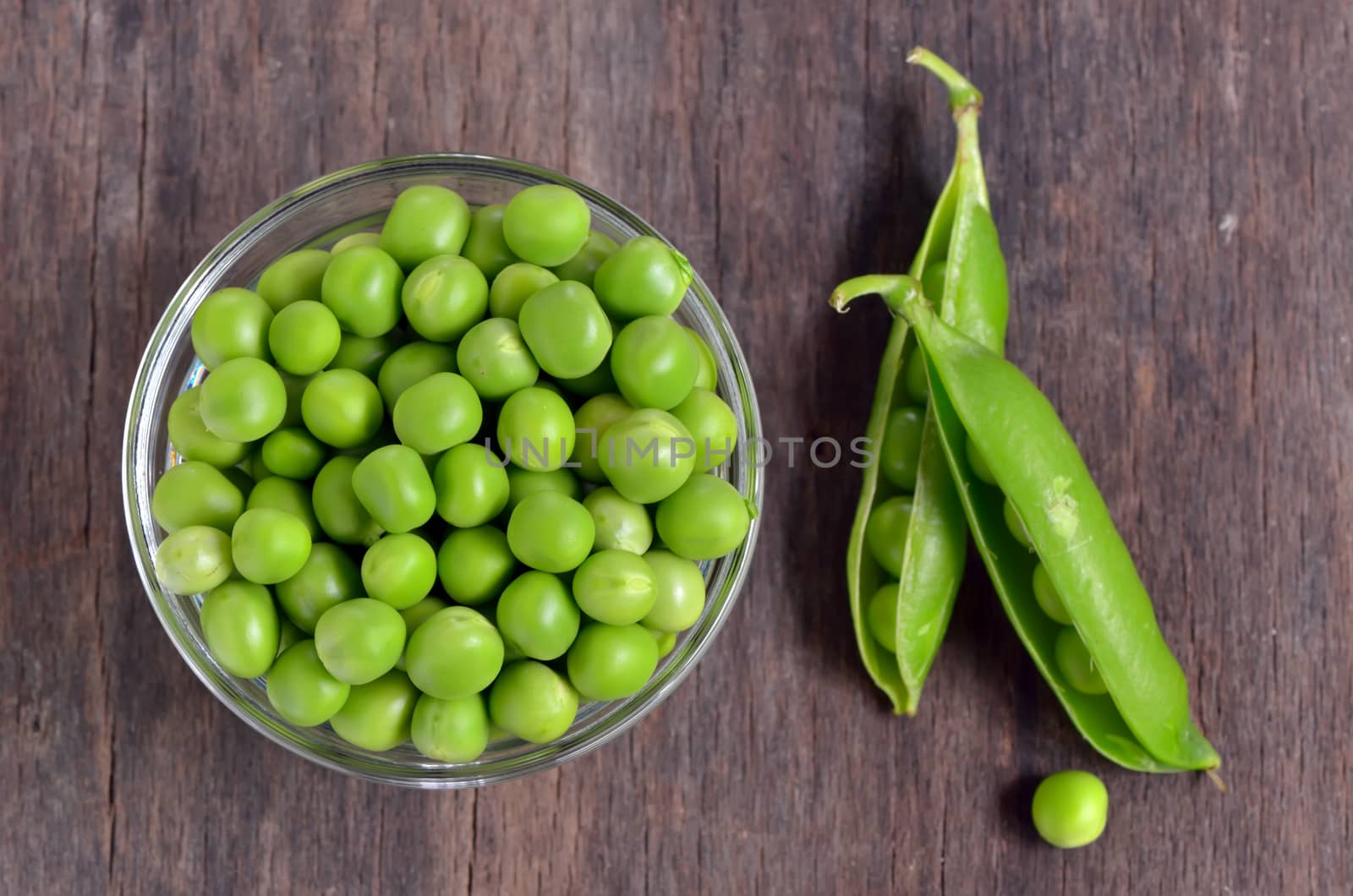 Close up of fresh peas on wooden table