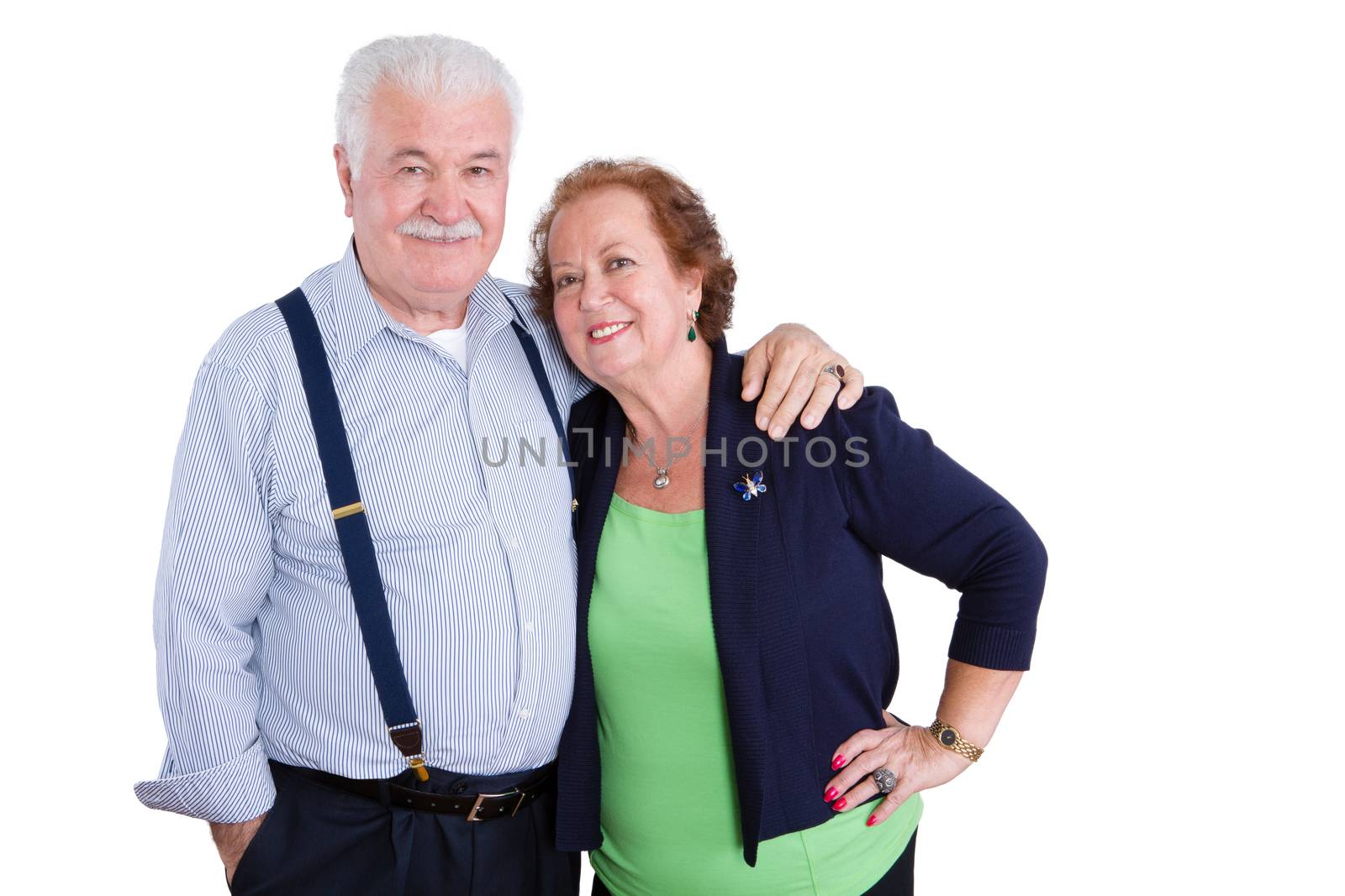 Married senior husband and wife standing together in harmony looking at camera over white background