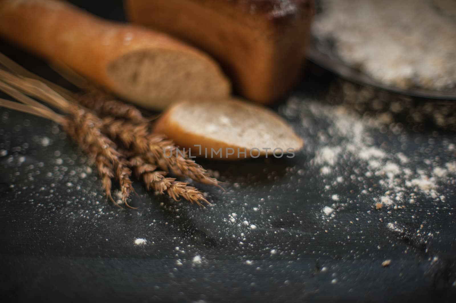Bread composition with wheats. Very shallow DOF photo and specific art curly bokeh for extra volume.