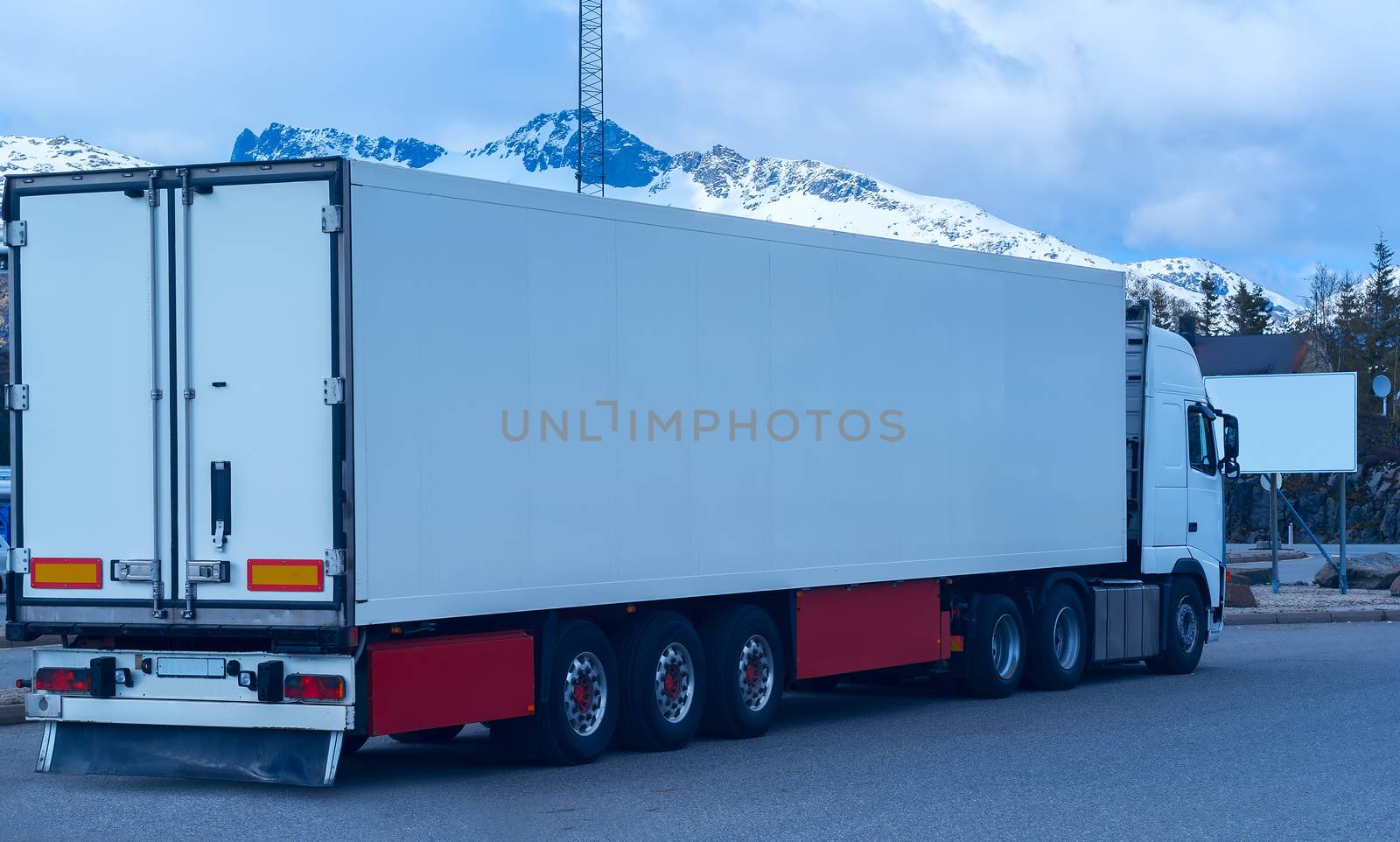 White refrigerated truck on background of the mountains