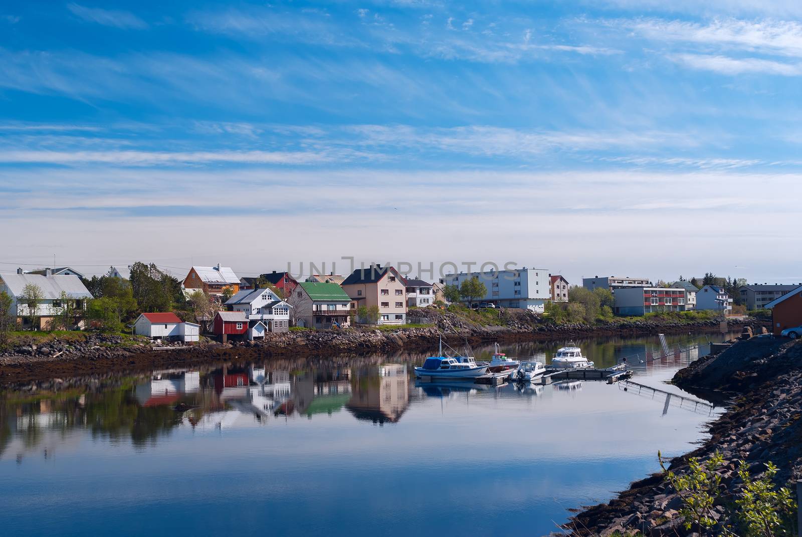 Village on the norwegian island with reflection in water by BIG_TAU