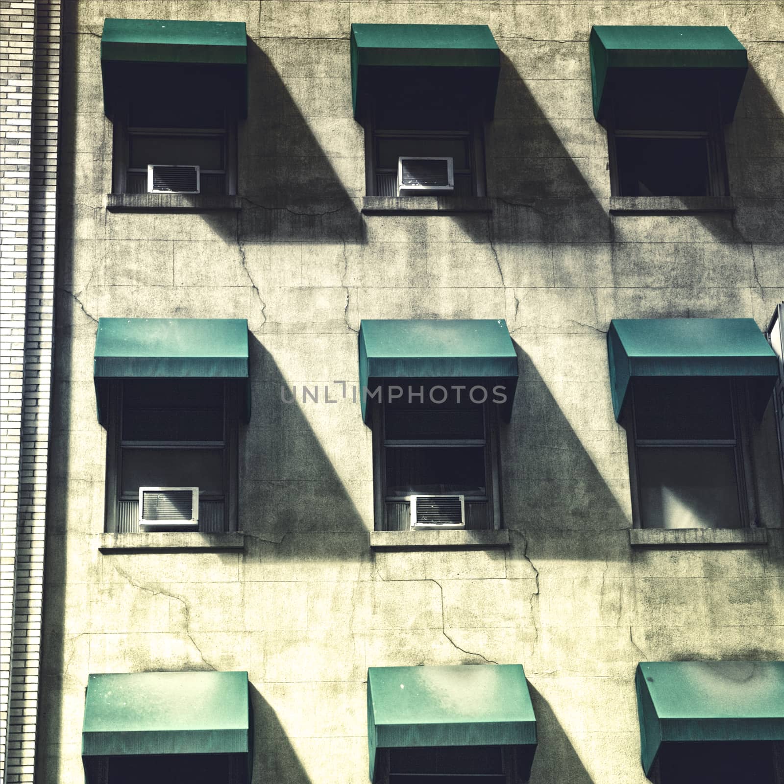 Green shades on weathered building, City life