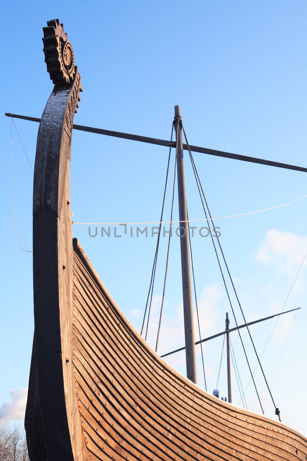 Fragment of ancient Viking ship named Drakkar against blue sky