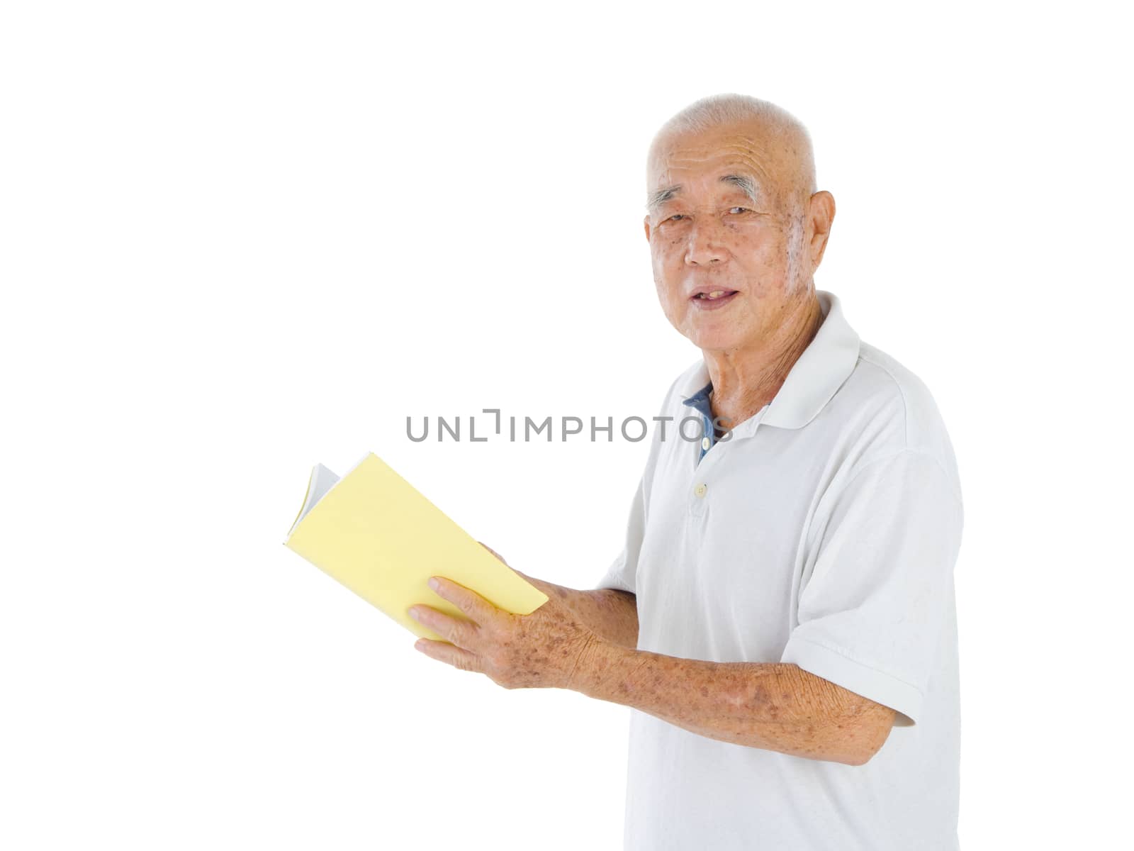 Portrait of senior man standing and reading a book over white background