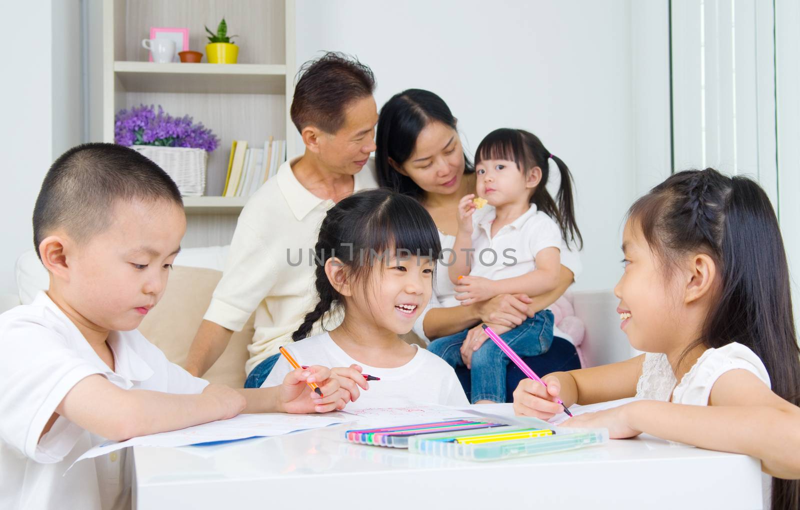 asian family doing school homework at living room