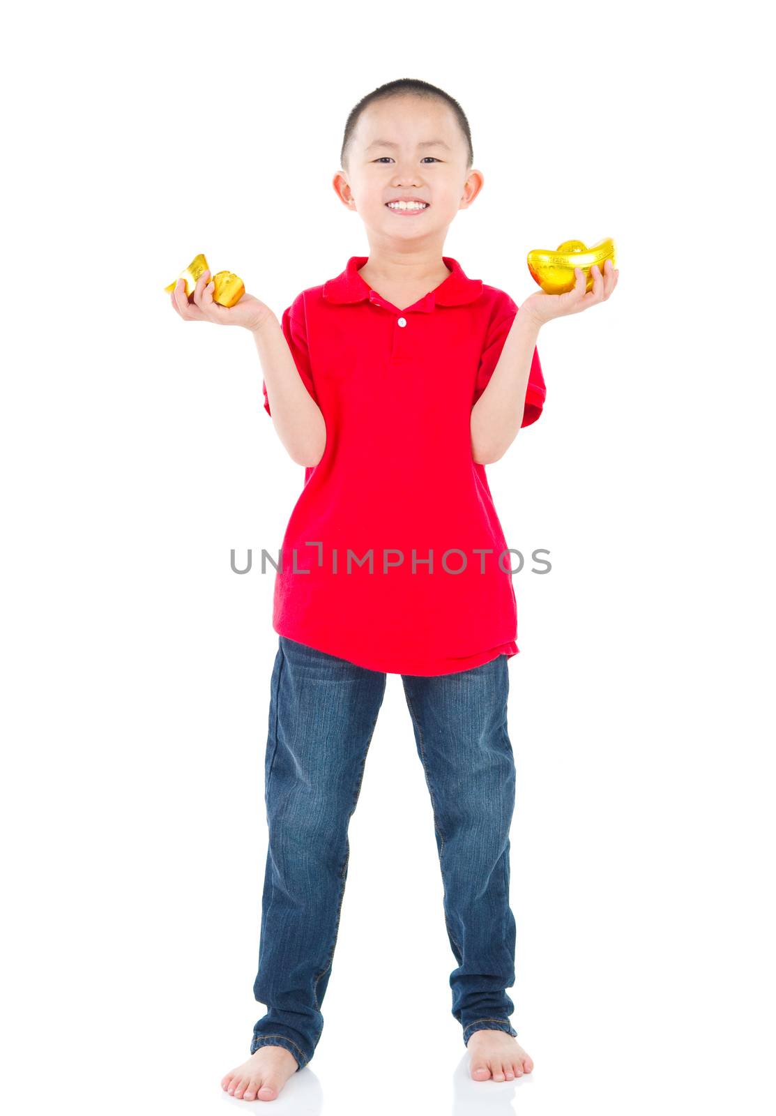 Full length China boy, holding a gold ingot standing isolated on white background