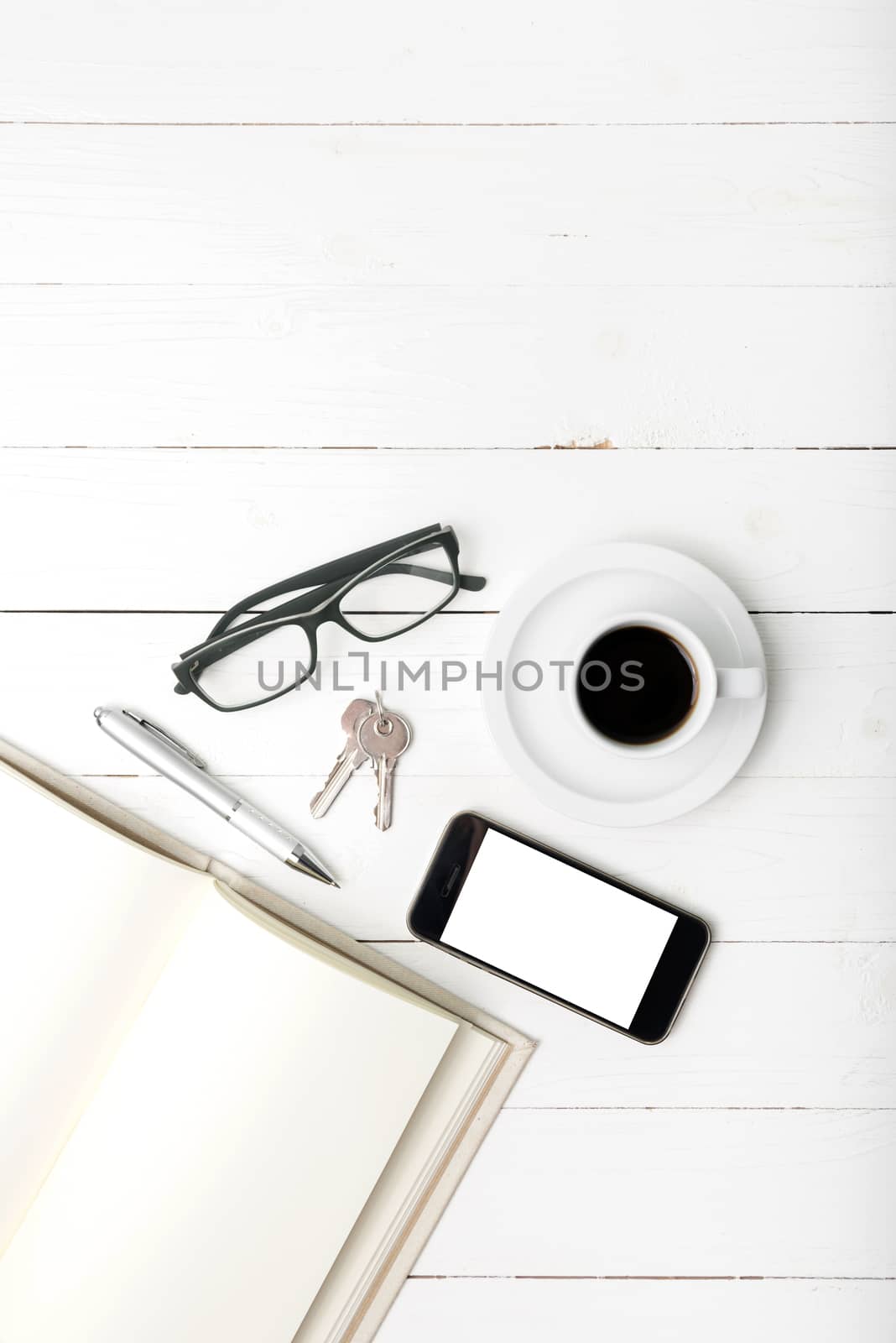 coffee cup with phone, key,eyeglasses and open notebook by ammza12