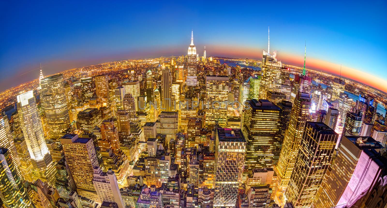 New York City. Manhattan downtown skyline with illuminated Empire State Building and skyscrapers at dusk seen from observation deck. Panoramic fish eye view.