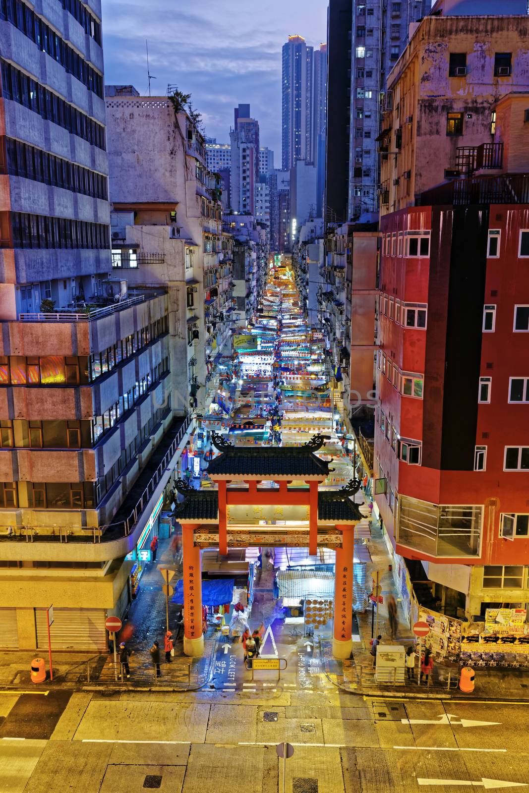 HONG KONG, CHINA - DEC 27, 2015: Crowded people walk through the market on December 27, 2015 in Mong Kok, Hong Kong. Mong Kok, Hong Kong is the highest population density place in the world.