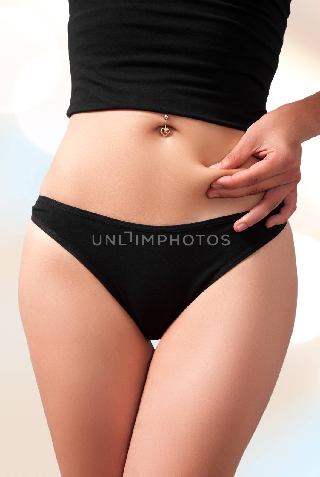 Woman`s slim figure in black underwear. Holding abdomen fat, isolated with work path.
