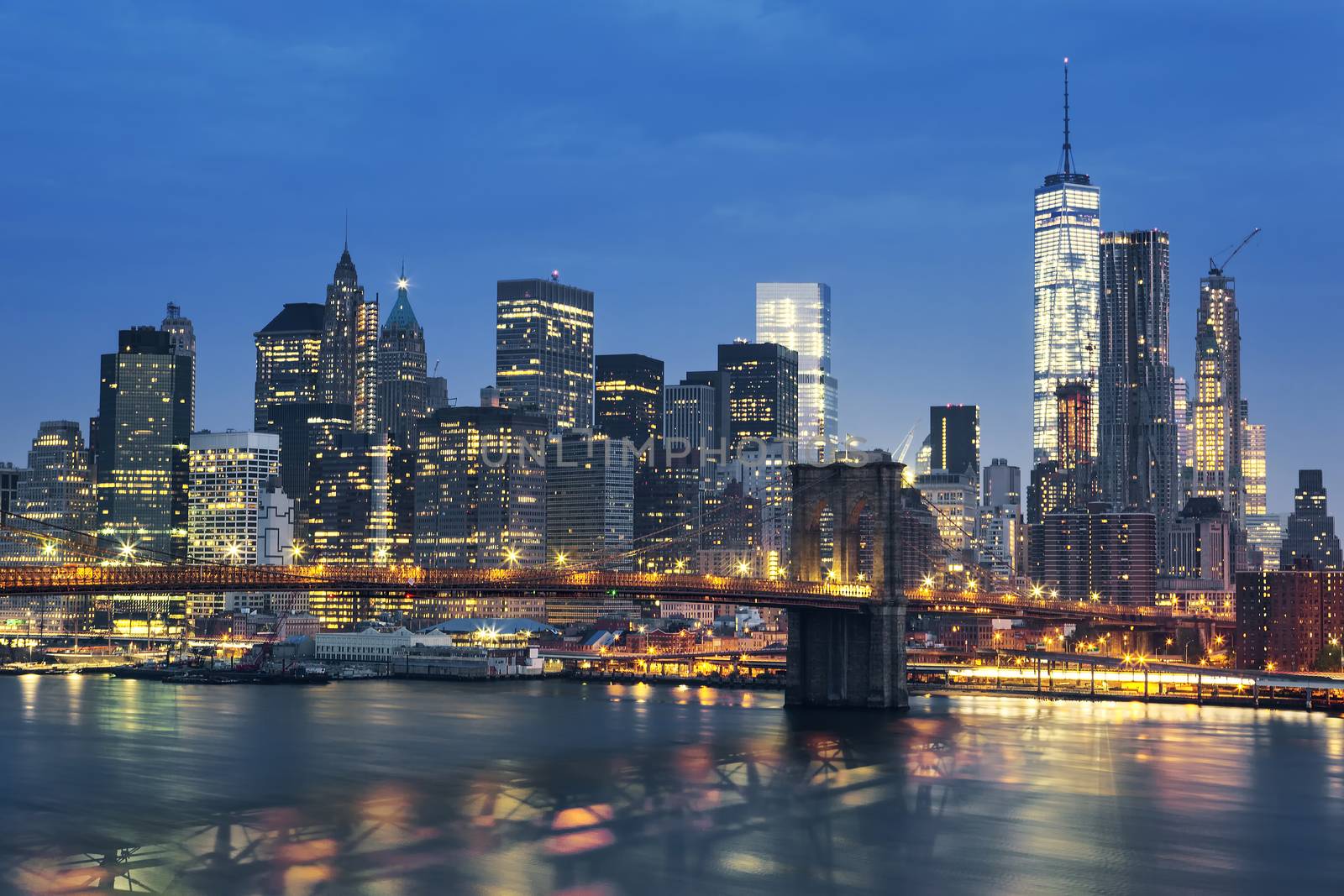 New York City Manhattan midtown at dusk with Brooklyn Bridge. USA.