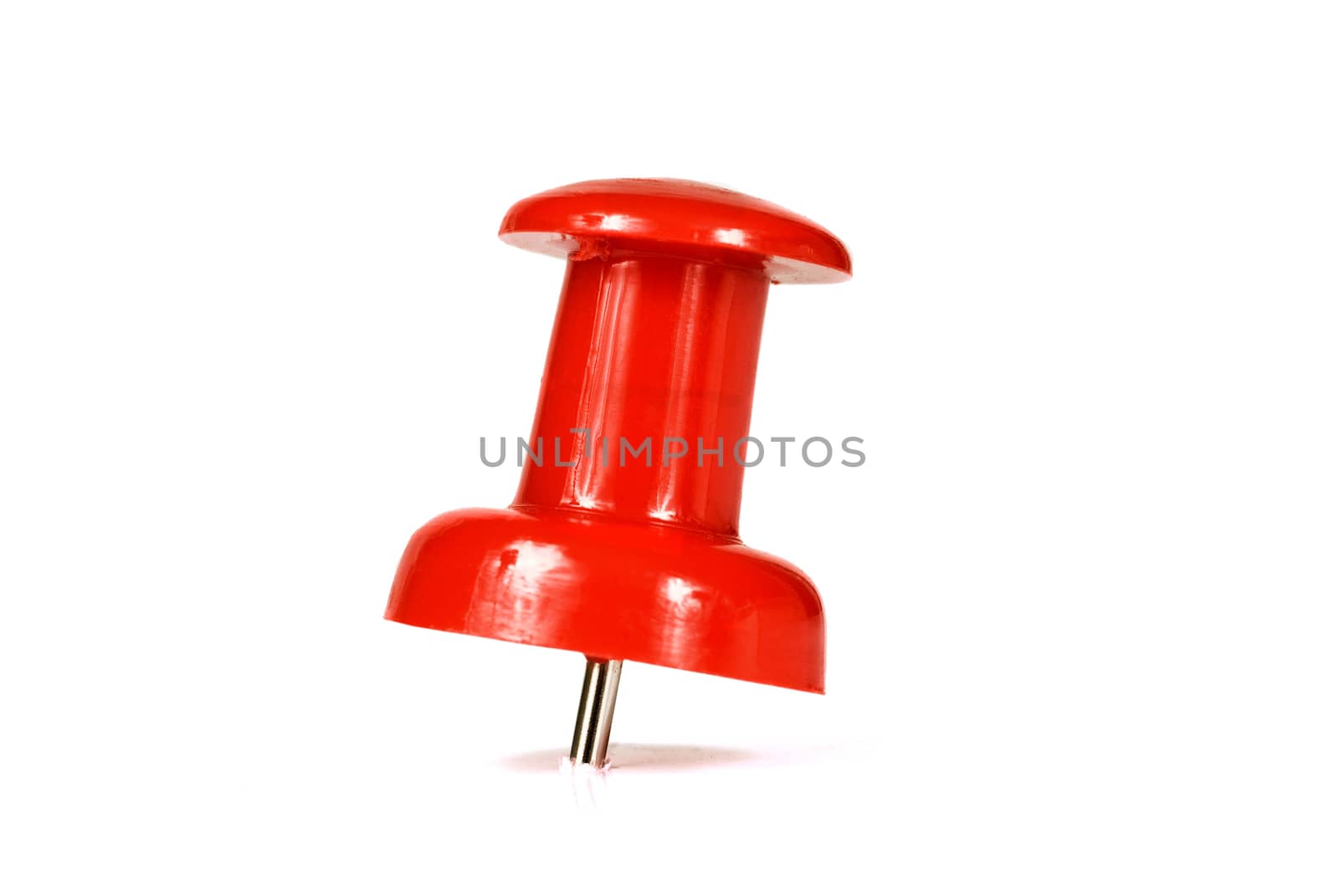 Macro shot of a red pushpin isolated on a white background