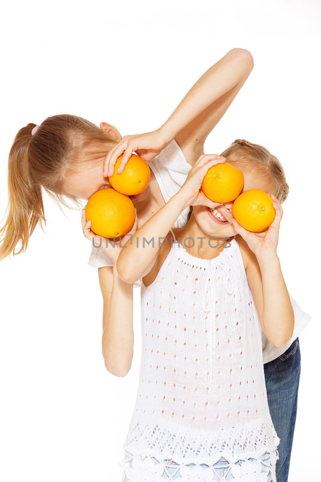 Beauty young girls with fresh oranges. Healthy lifestyle. Happiness. White background.