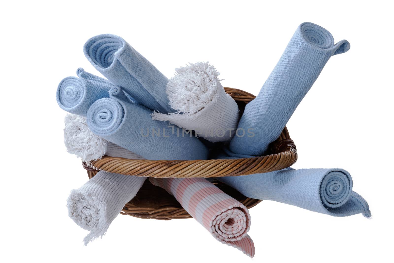 High Angle View of Assorted Newly Washed Rolled Rugs in a Wooden Basket Isolated on a White Background.