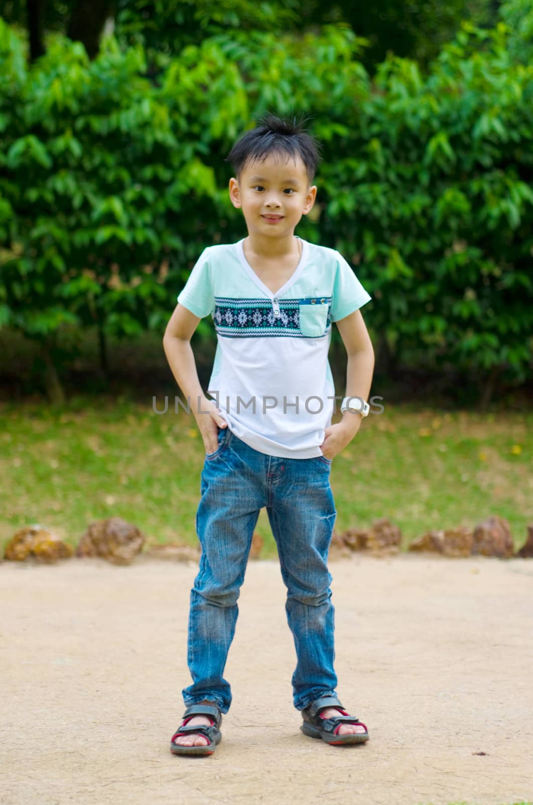 Outdoor portrait of little asian boy