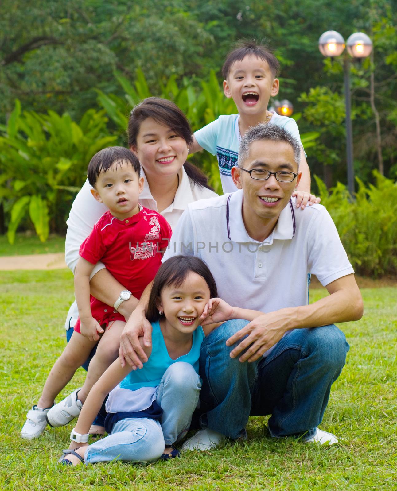 Outdoor portrait of happy asian family