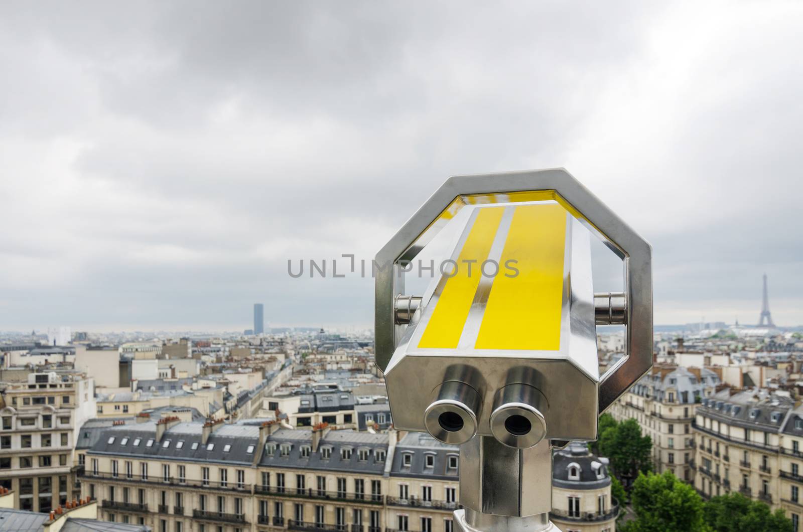 Binocular looking out to paris skyline by siraanamwong