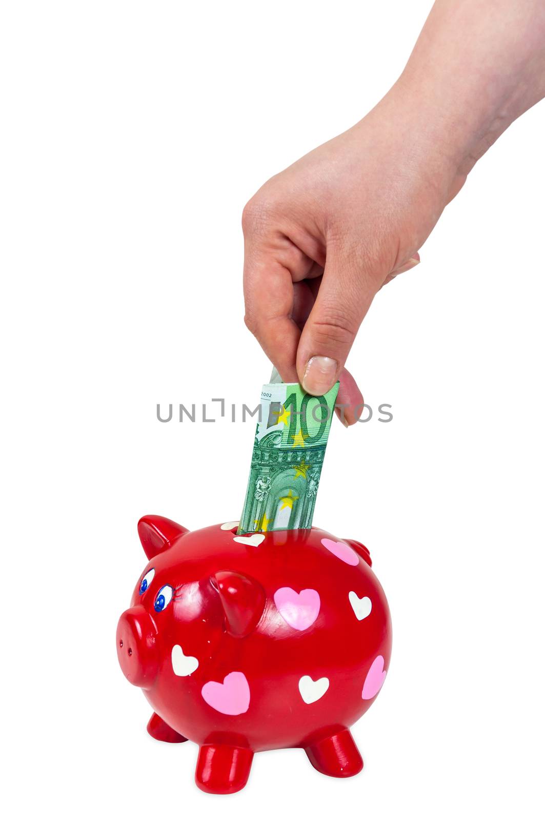 Hand inserting 100 euro banknote into piggy bank isolated on white background with clipping path