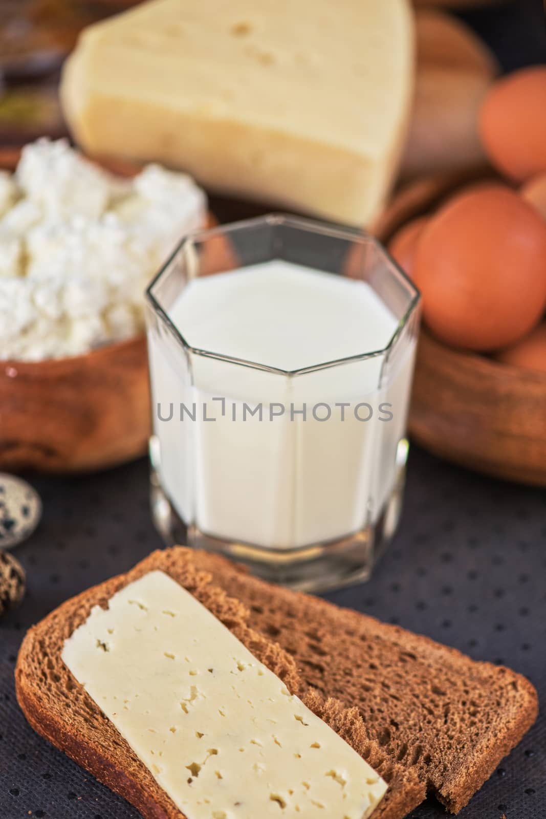 still life with dairy products as milk, cheese cottage cheese eggs and bread 