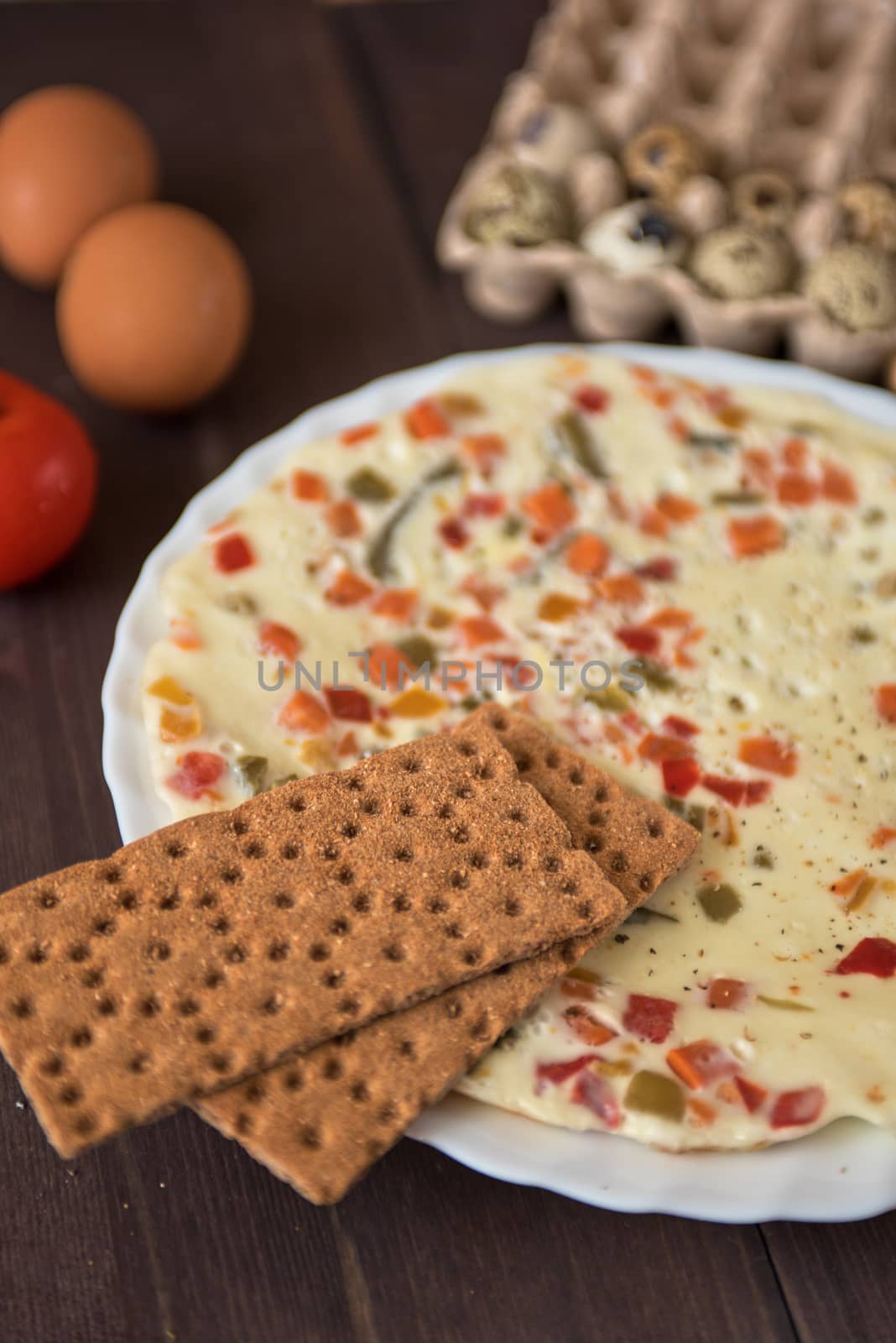 baked omelette with different eggs and vegetables with rye small load of bread