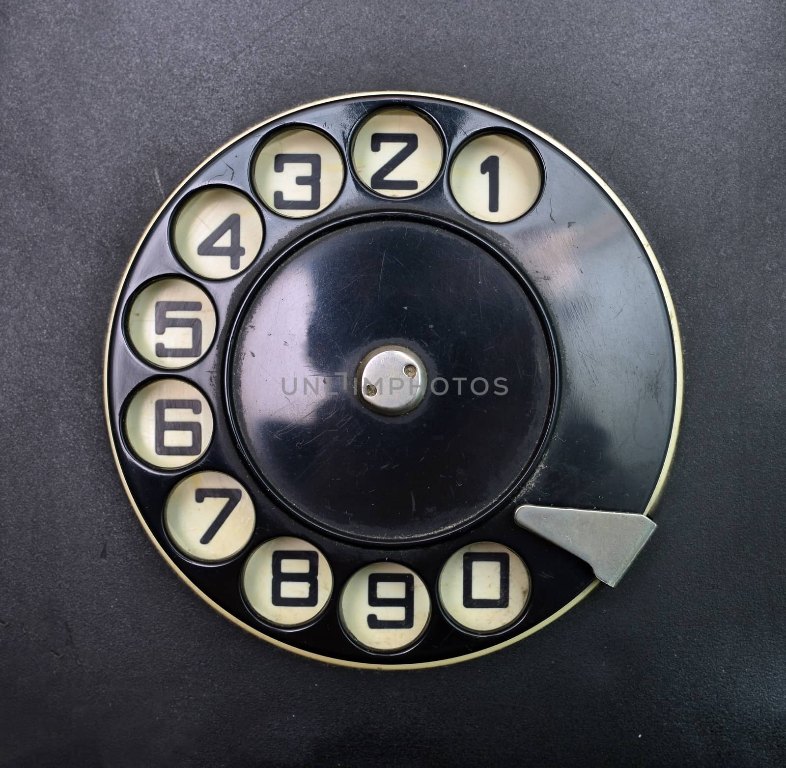 black vintage phone dial disk over plastic