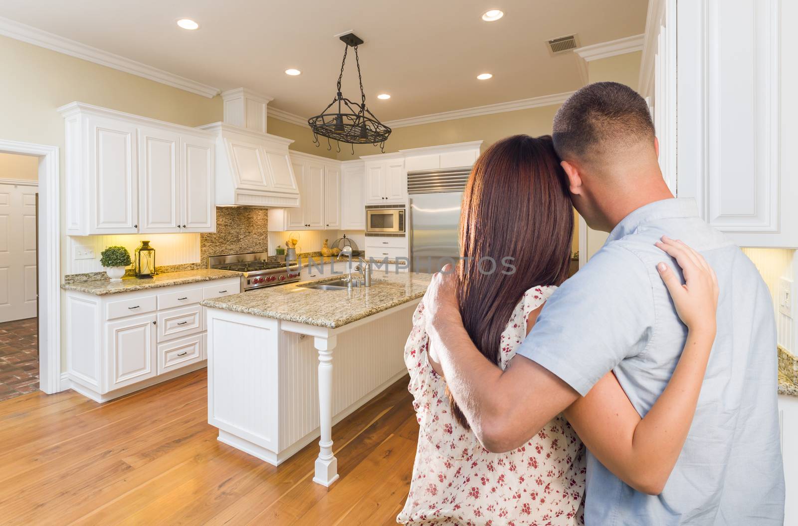 Young Hopeful Military Couple Looking At Custom Kitchen by Feverpitched