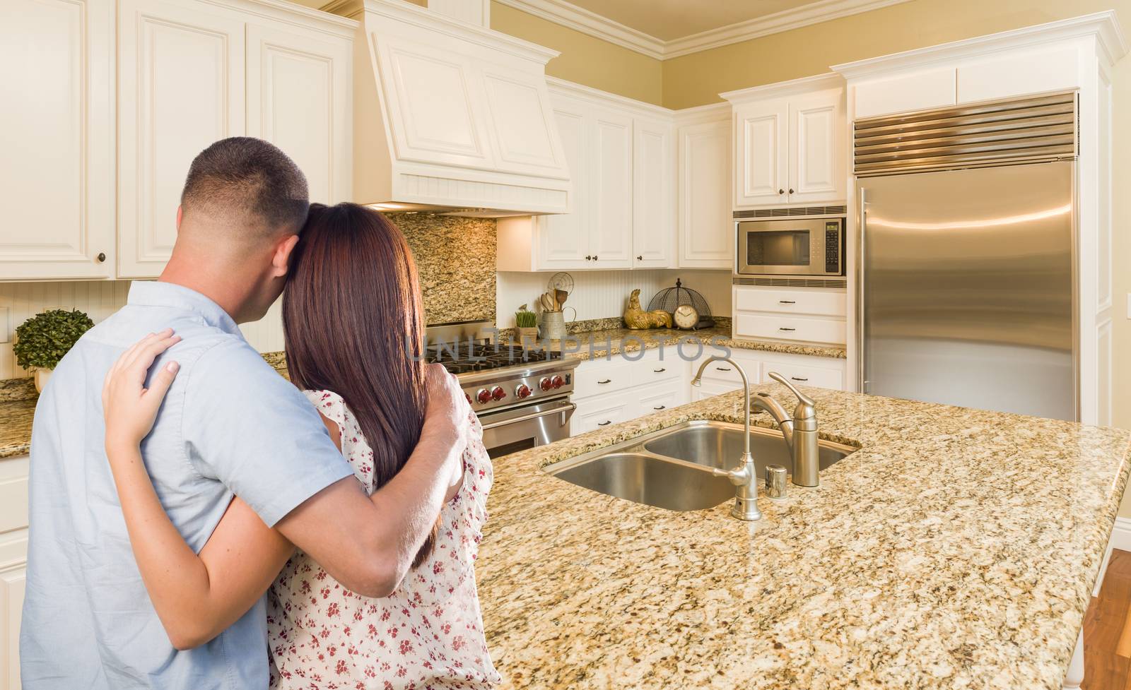 Young Hopeful Military Couple Looking At Custom Kitchen by Feverpitched