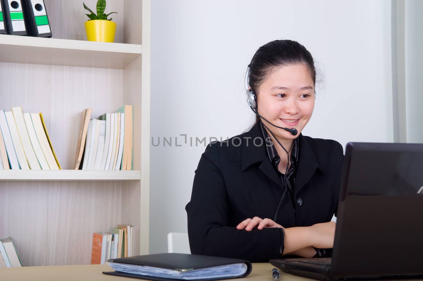 Beautiful asia young business woman with headset and laktop