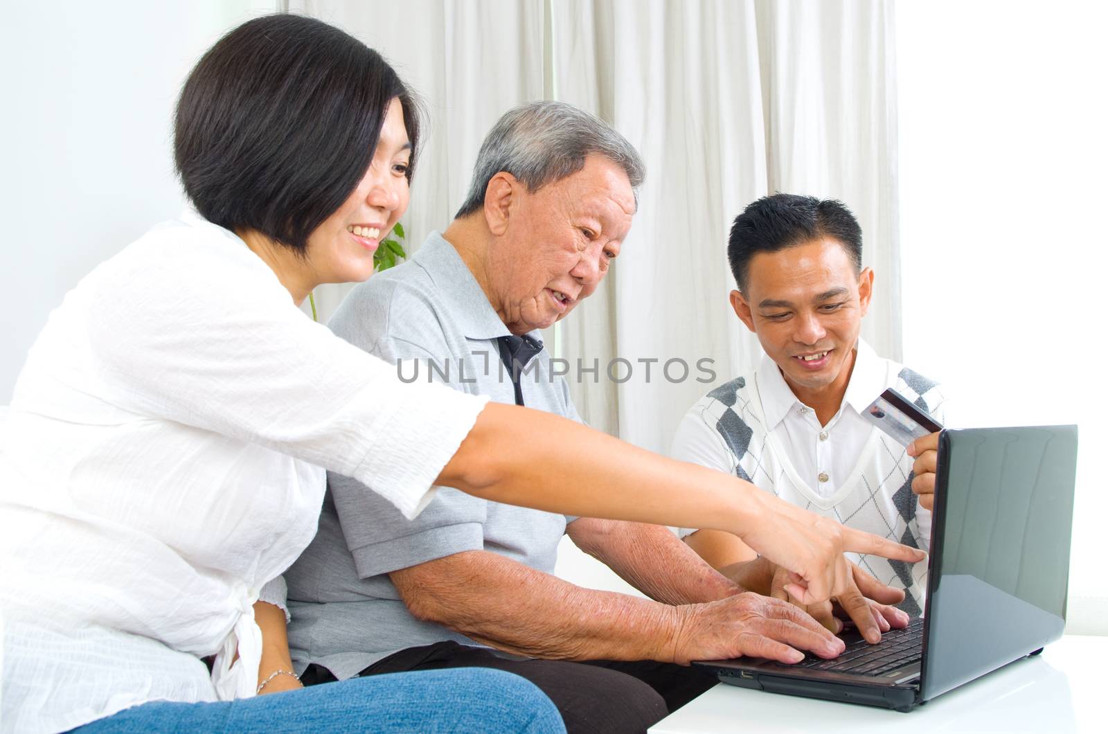 Asian senior man learns to use online internet banking