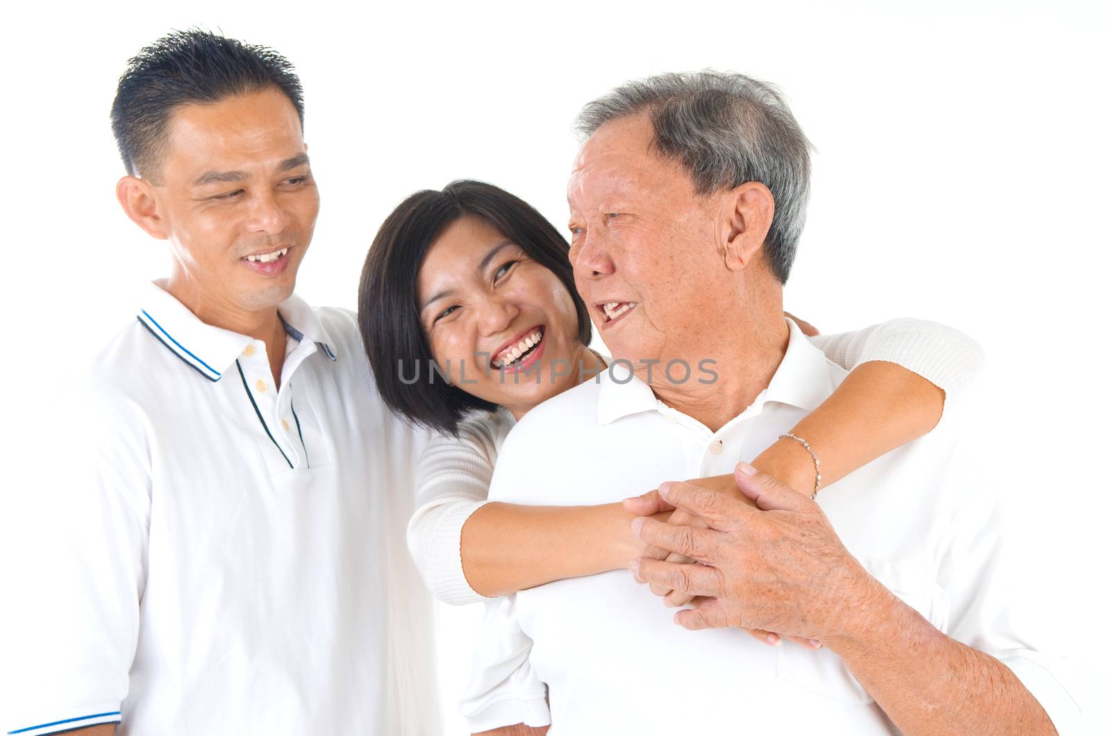 Senior man with his son and daughter. Happy Asian family senior father and adults offspring having fun time at indoor studio.