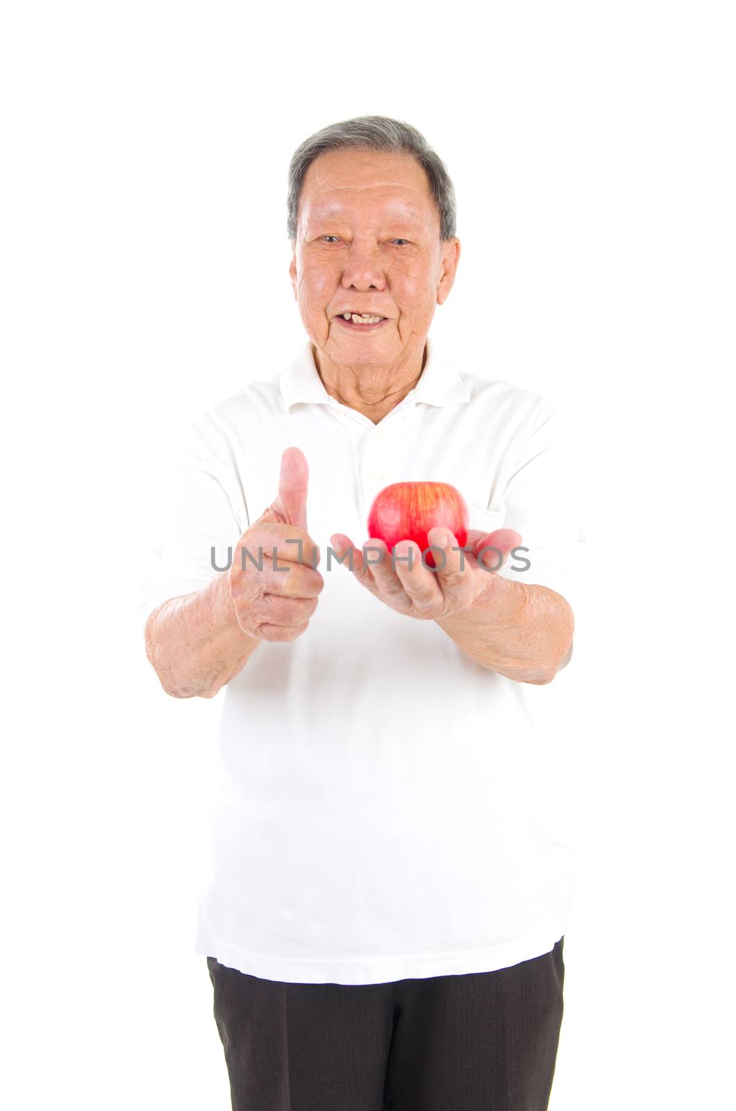 Closeup portrait senior man holding an apple, isolated on white background.